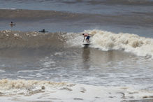Some board riders taking advantage of bigger waves